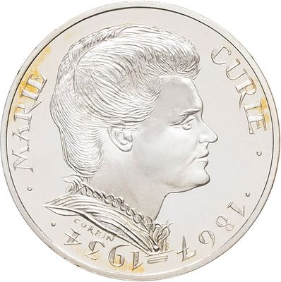 a close up of a coin with a woman ' s face on it
