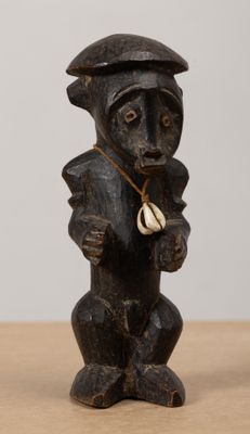 a wooden statue of a bear with a hat on it ' s head