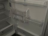 an open refrigerator with its door open in a kitchen