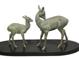 statue of a deer and a baby deer on a black base