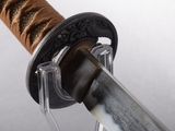 a close up of a sword with a wooden handle