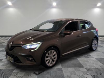 La voiture marron est garée sur un sol en carrelage à damier.