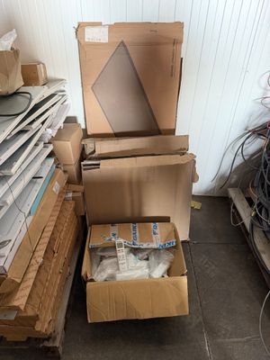 a pile of cardboard boxes and other items in a room