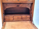 an old wooden desk with a drawer on it
