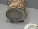 a vase and a plate sitting on a table