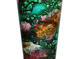 a glass vase that has a green and red design on it