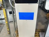 an image of a white and blue gas pump sitting on top of a wooden cart