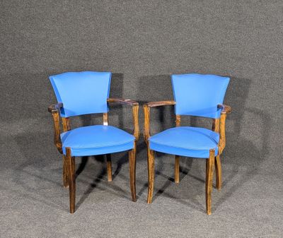 pair of blue chairs against a gray background