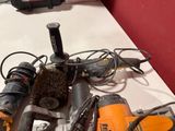 a pile of tools on a table with a red wall in the background