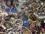 a pile of assorted jewelry sitting on a table