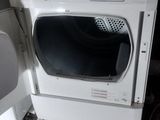 a white washer and dryer sitting next to each other on the floor