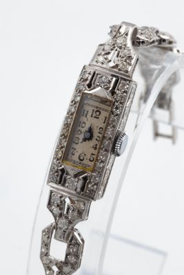 a watch that is on display on a clear stand