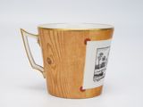a coffee cup with a picture on it sitting on a table