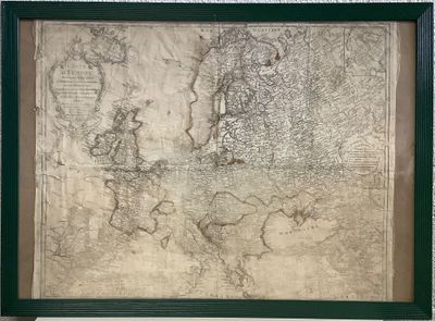 an old map of europe in a green frame on a wall