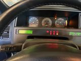a steering wheel and dashboard of a car with a clock on it