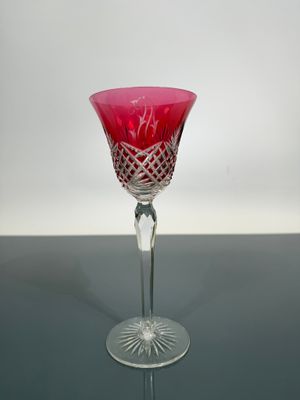red glass goblet on a table with a white background