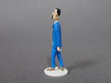 a figurine of a man in a blue suit and tie