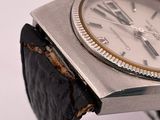 a watch that is sitting on top of a piece of paper