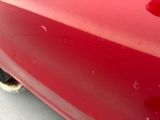 a close up of a red car with a black rim