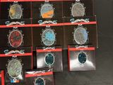 several different types of brooches are displayed in a display case