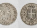 two silver coins, one with a crown and the other with a shield