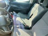the interior of a small car with a steering wheel and a dashboard