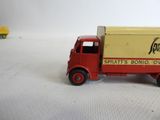 a toy truck that is sitting on a white surface