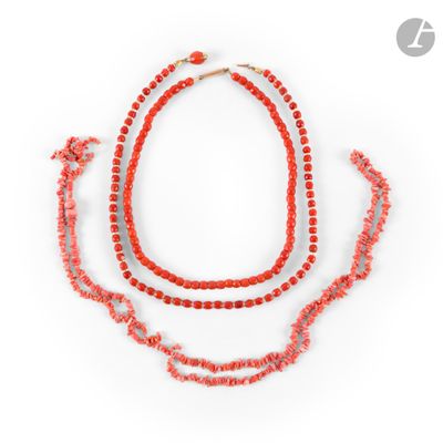 a close up of a necklace with red beads on a white background
