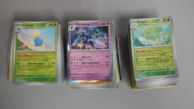 trois types différents de cartes Pokémon posées sur une table