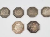 six different types of coins are shown on a white surface
