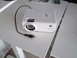 a white projector sitting on a white desk