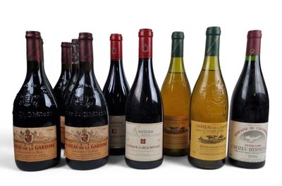 several bottles of wine are lined up on a white surface