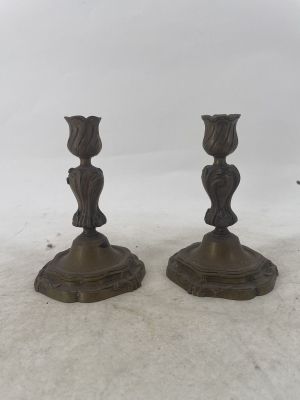pair of bronze candlesticks in the form of a woman ' s head
