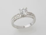 a close up of a diamond ring on a white background