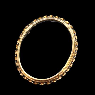 an old gold ring with a braid design
