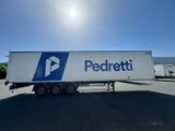 the semi trailer is parked in a parking lot with the sun shining on it
