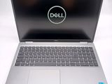 a close up of a dell laptop computer on a white surface
