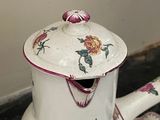a white tea pot sitting on top of a table