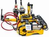 a yellow machine that is sitting on a white surface