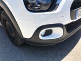 a close up of the front end of a white car