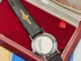 a watch sitting in a red box on a table