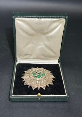 a close up of a box with a brooch on it