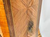 a close up of a wooden cabinet on a wooden floor