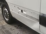 a white van that is parked on the side of the road