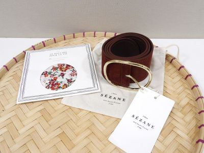 a belt and a book on a tray on a table