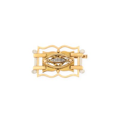 a close up of a gold and diamond broochle