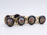 four black and gold bracelets with pictures of buildings on them
