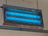 a blue light hanging from the ceiling of a room
