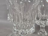 several empty wine glasses sitting on top of a white table