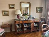 an image of a living room with a dresser and a mirror